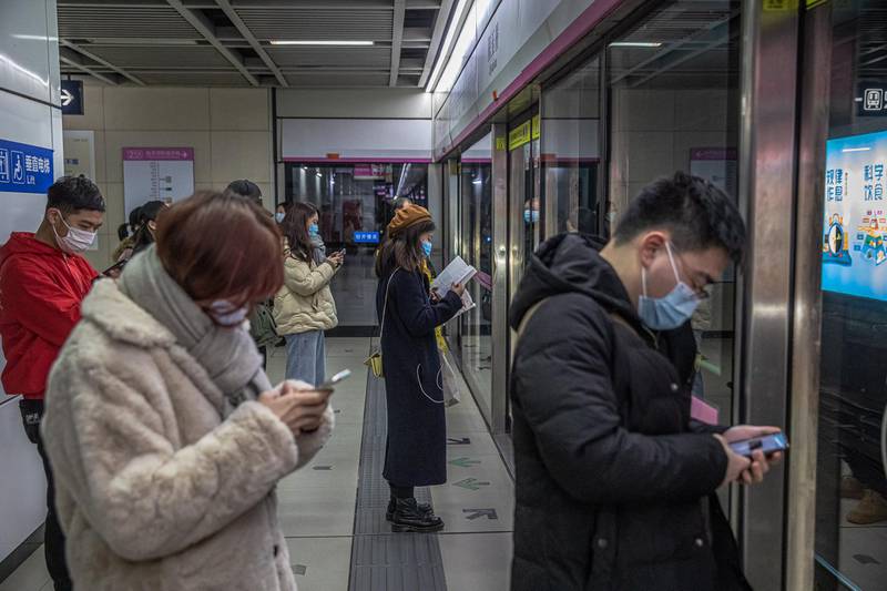 Passengers wearing protective face masks wait at a station for a subway during an evening rush hour in Wuhan, China. Life in Wuhan, a Chinese city of more than 11 million, which nearly a year ago became the epicenter of the coronavirus outbreak is returning to normal. Since May the capital of Hubei province has not recorded locally-transmitted cases of Covid-19.  EPA