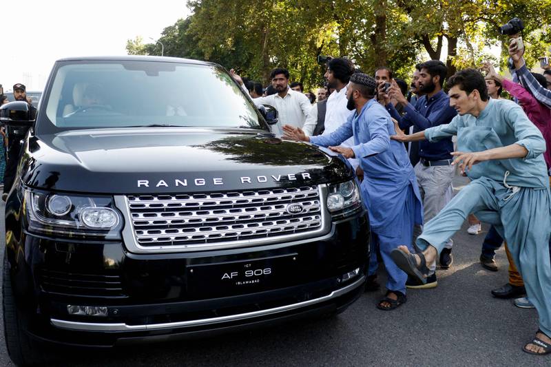 Supporters of the PTI beat the car of government lawyer and petitioner Mohsin Nawaz Ranjha, during a protest outside the Election commission office in Islamabad. AFP
