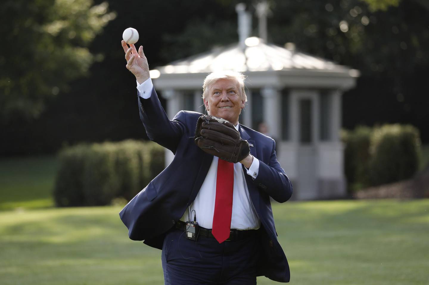 U.S. President Donald Trump throws a baseball on the South Lawn of the White House in Washington, D.C., U.S., on Thursday, July 23, 2020. Trump met with youth baseball players to celebrate Opening Day of the Major League Baseball (MLB) season. Photographer: Yuri Gripas/Abaca/Bloomberg