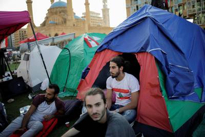 Protesters sit outside tents at Martyr's square in downtown Beirut. REUTERS