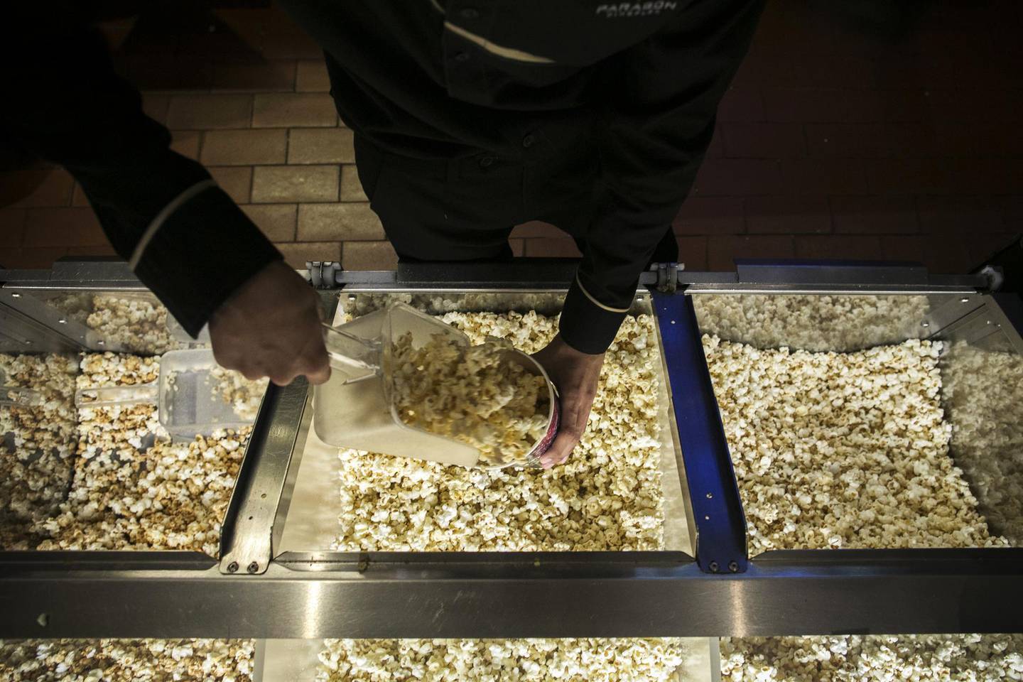 An employee scoops popcorn at a concessions stand at the Paragon Cineplex cinema, operated by Major Cineplex Group Pcl, in Bangkok, Thailand, on Saturday, May 11, 2019. Walt Disney Co.'s blockbuster "Avengers: Endgame" has turned Thailand's Major Cineplex Group into one of Asia's best-performing cinema stocks this year. Photographer: Brent Lewin/Bloomberg