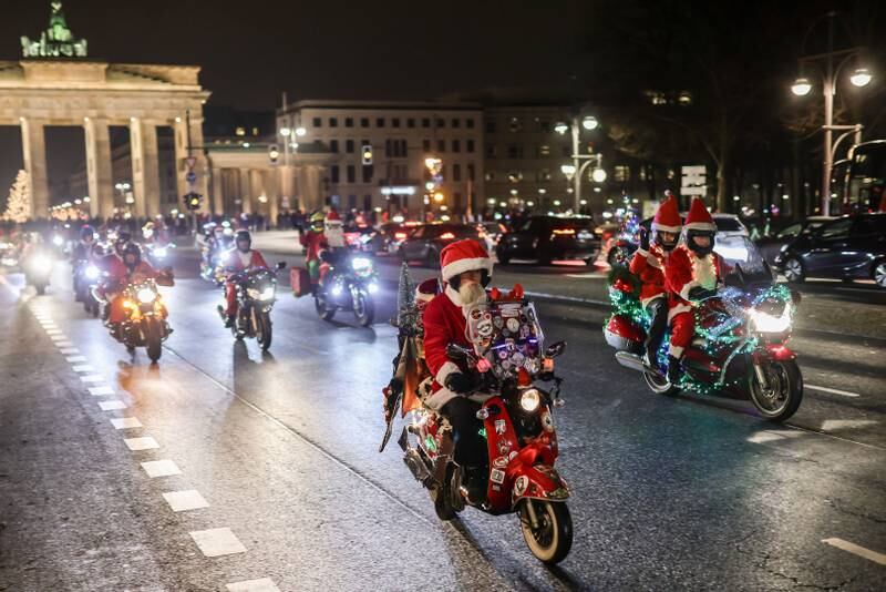 Motorcyclists get into the festive spirit in Berlin to deliver gifts to the needy. About 200 Santas on wheels took part. Getty 