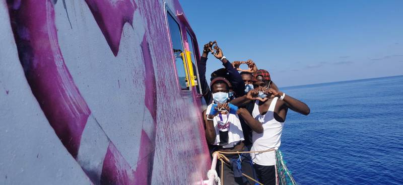 Migrants pose for a photo after being rescued by the Louise Michel. MV Louise Michel via Reuters