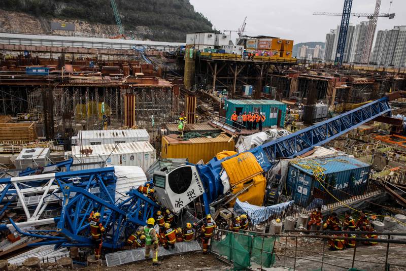 Members of the Urban Search And Rescue team work on a collapsed crane in Hong Kong, where two people died and six were injured at a construction site. AFP