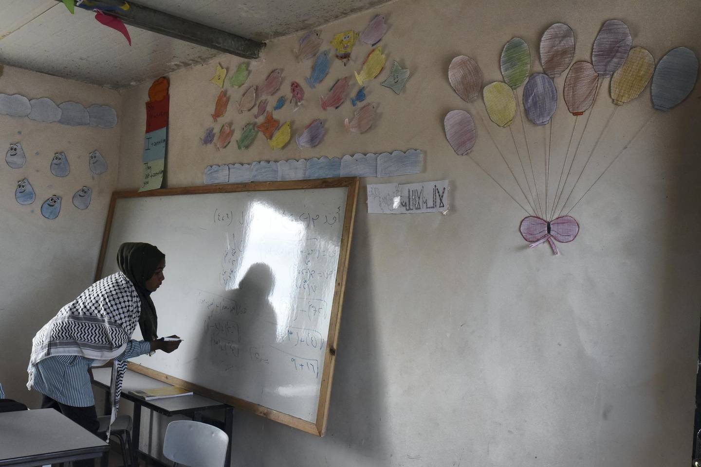 Noor Abu Rasheed, writes an equation on the board. The 14-year-old said maths is her favourite subject and her grades have improved since the Ras a-Tin school opened, in Ras a-Tin, north-east of Ramallah in the occupied West Bank. Rose Scammell for The National