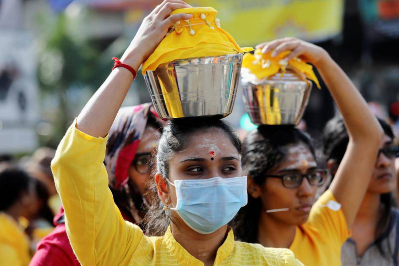 Hindu devotee wears a mask as she carries a milk pot on her head at a shrine in Batu Caves during Thaipusam, following the outbreak of a new coronavirus in China, in Kuala Lumpur, Malaysia. REUTERS