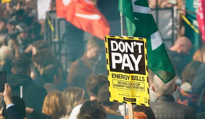 A protester holds up a placard at a rally in London on Saturday against high energy bills. AFP