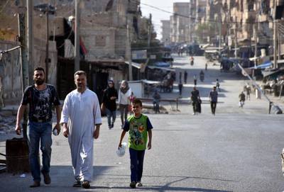 RESIZED. People walk along a street in Deir al Zor, Syria in this handout picture provided by SANA on September 11, 2017. SANA/Handout via REUTERS ATTENTION EDITORS - THIS PICTURE WAS PROVIDED BY A THIRD PARTY. REUTERS IS UNABLE TO INDEPENDENTLY VERIFY THE AUTHENTICITY, CONTENT, LOCATION OR DATE OF THIS IMAGE.