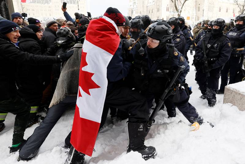 Canadian police officers face off with protesters as they worked to restore normality to the capital Ottawa on February 19. Reuters