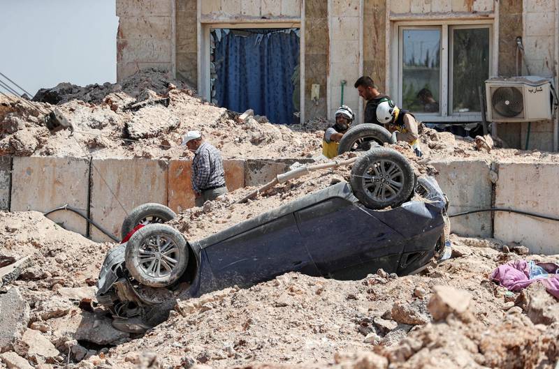 Members of the Syrian Civil Defence, also known as the "White Helmets", use a winch to flip an overturned vehicle in the rubble outside a health facility that was hit by a reported Russian air strike after midnight in town of Urum al-Kubra in the western countryside of Syria's northern Aleppo province just before a truce went into effect, on August 31, 2019. - Air strikes on Syria's northwestern Idlib region stopped on August 31, a war monitor said, after the government agreed to a Russian-backed ceasefire following four months of deadly bombardment. The truce is the second such agreement since an August 1 ceasefire deal broke down only days after going into effect, prompting Damascus and regime ally Moscow to resume bombardment. (Photo by Omar HAJ KADOUR / AFP)
