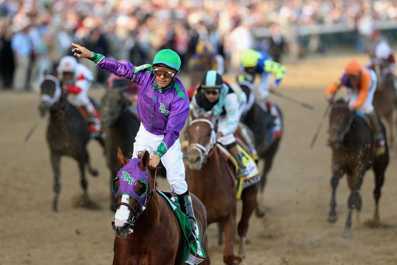 Jockey Victor Espinoza celebrates atop of California Chrome after crossing the finish line. Matthew Stockman / Getty Images / AFP