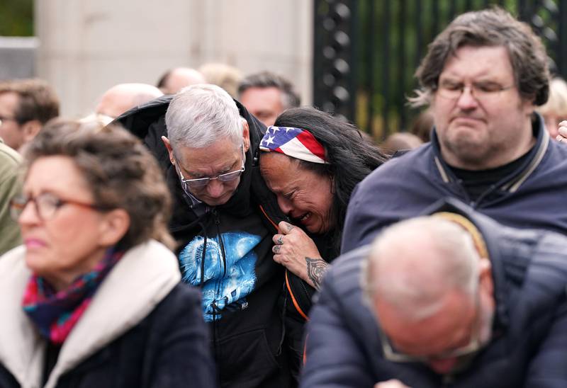 Members of the public on the Mall become emotional during the funeral. PA