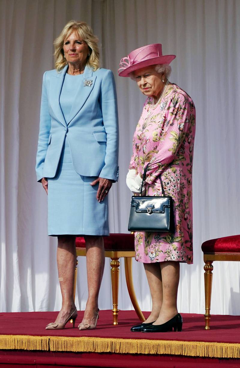 Jill Biden, in a powder blue dress and blazer, with Queen Elizabeth II during a visit to Windsor Castle on June 13, 2021 in England. Getty Images