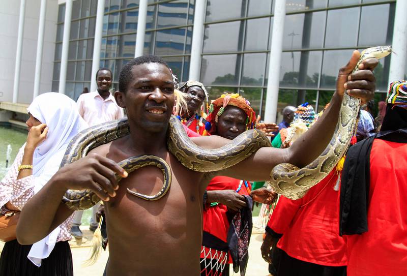 A man carries a snake at the rally. 
