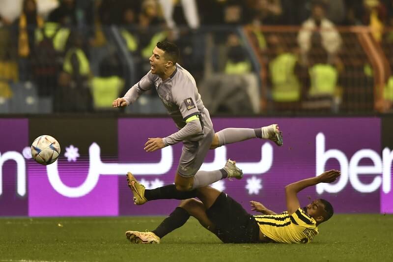 Al Nassr's Cristiano Ronaldo is tackled by Al Ittihad's Hamdan Al Shamrani. EPA