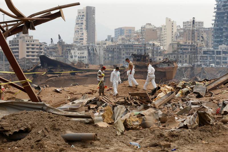Members of forensic team walk near rubble at the site of Tuesday's blast, at Beirut's port area, Lebanon. Reuters