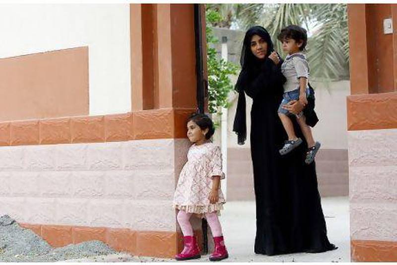 Al Yamahi with her daughter Mahra Naj Al Darmaki, 4, and son Mohammed Naj Al Darmaki, 2, at her residence in Kalba. Satish Kumar / The National