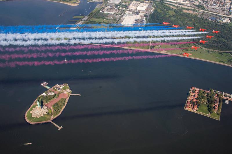 Britain's Royal Air Force aerobatic team the Red Arrows fly over the Statue of Liberty in New York City, U.S.   Reuters
