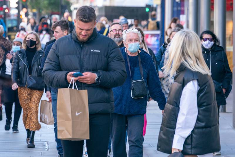 Shoppers on Oxford Street, in central London. The Department of Health and Social Care is calling on eligible people to have their Covid-19 booster shots.