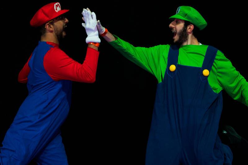 Bibi Zumot of Jordan, left, dressed as Mario, and Mohamed Rashed of Egypt, right, dressed as Luigi, high-five at the Middle East Film& Comic Con. AP Photo