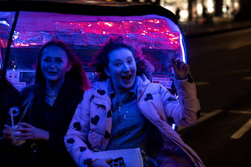 Two women enjoy a ride in a Rickshaw in Piccadilly. Getty Images