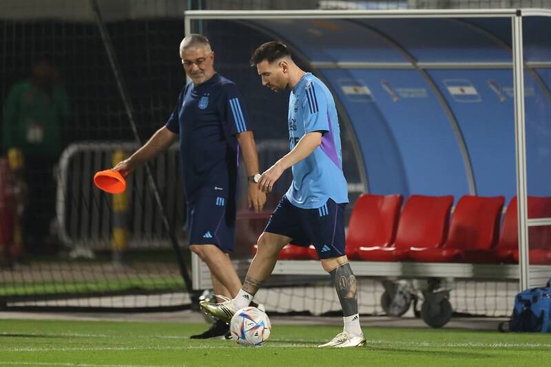 Lionel Messi walks alongside medical staff member Javier Martinez. Getty