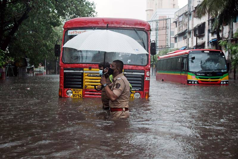 A policeman is on hand when a bus breaks down on a flooded street after cyclone Tauktae hit the city of Mumbai. EPA
