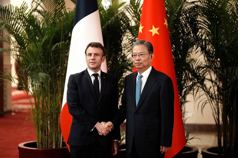 China's National People's Congress chairman Zhao Leji with French President Emmanuel Macron at the Great Hall of the People in Beijing. AFP