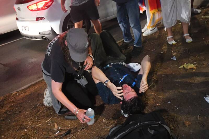 A member of the press lies on the ground after sustaining an injury during clashes between the Serbian Community and Victorian Police officers in Melbourne, Australia.  Djokovic was to be released from an immigration detention center in Melbourne after an order by the Federal Circuit Court.  The tennis world number one had been staying in a hotel-turned-detention center after his visa was revoked upon landing in Australia.   EPA
