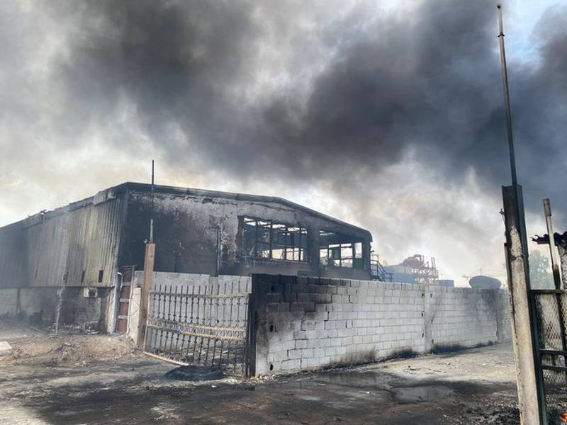 Sunday's fire damaged a warehouse that stored scrap heavy vehicles and tanks. Photo: Abu Dhabi Police