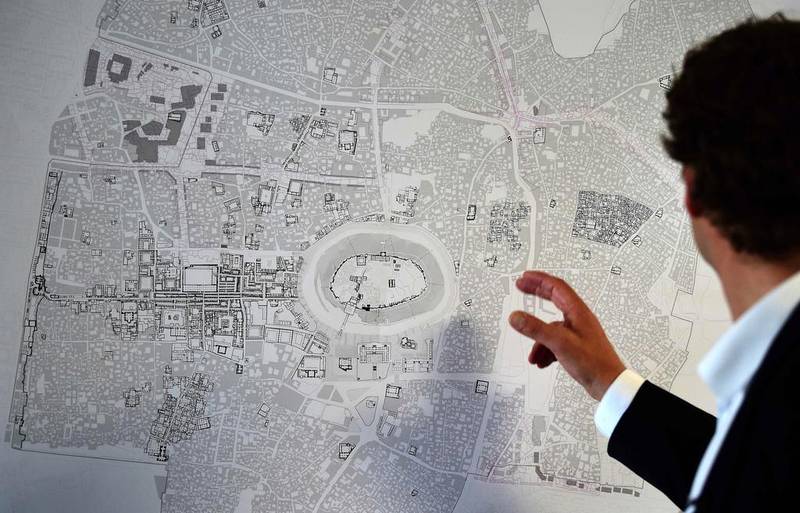 Urban planner Christoph Wessling points out locations on a map showing Syria's town of Aleppo. Lebanon readies itself for business once reconstruction begins in Syria. Tobias Schwartz  / AFP