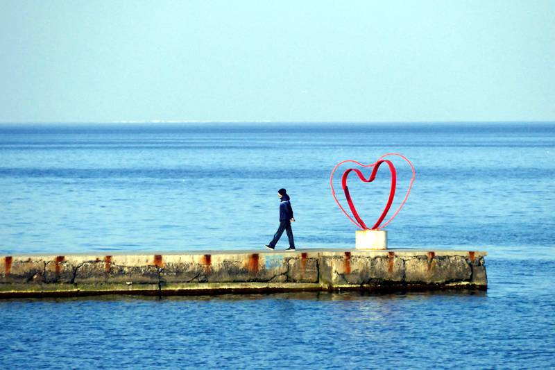 A man walks along a pier at Ukrainian Black Sea port Odesa, amid reports that encroaching Russian invasion forces are planning an assault on the city. Reuters