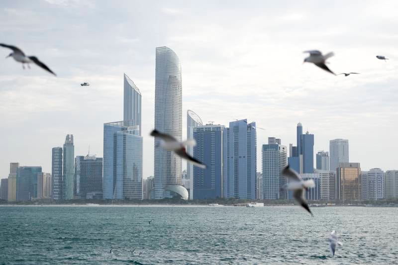 The Abu Dhabi skyline. Small UAE businesses with a revenue of Dh3 million or less can benefit from a new corporate tax relief programme. Khushnum Bhandari / The National