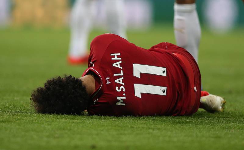 epa07547687 Liverpool's Mo Salah lies on the pitch after colliding with Newcastle United goalkeeper Martin Dubravka (not seen) during the English Premier League soccer match between Newcastle United and Liverpool FC at St James' Park in Newcastle, Britain, 04 May 2019.  EPA/NIGEL RODDIS EDITORIAL USE ONLY. No use with unauthorized audio, video, data, fixture lists, club/league logos or 'live' services. Online in-match use limited to 120 images, no video emulation. No use in betting, games or single club/league/player publications