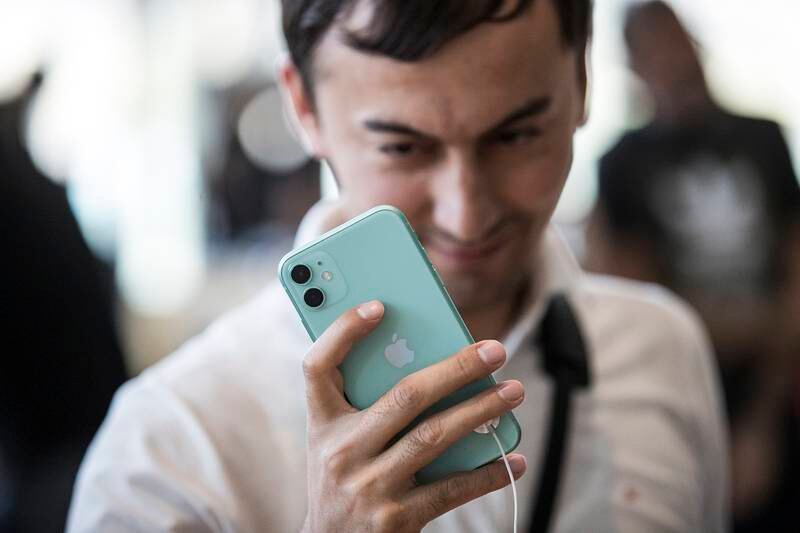 A customer looks at the iPhone 11 at an Apple store in Dubai Mall on September 20, 2019. EPA