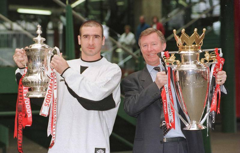 12th May 1996; Manchester United manager Alex Ferguson and Eric Cantona with the FA Cup and Premiership trophy on their arrival at Manchester's Victoria station. Mandatory Credit: Shaun Botterill/ALLSPORT