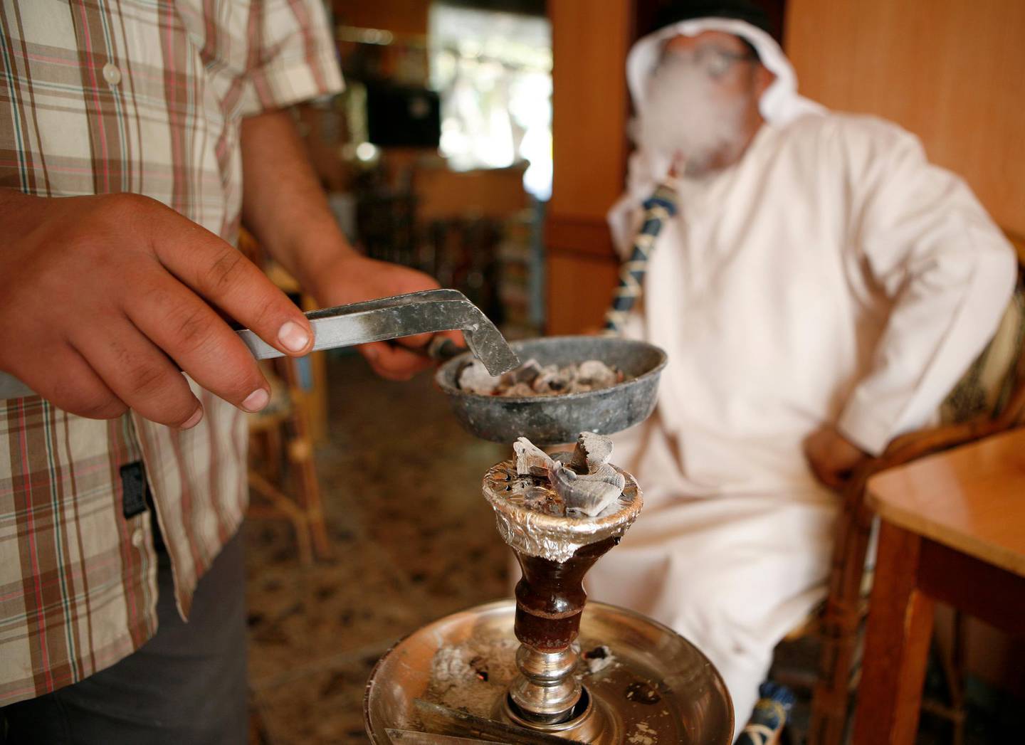 ABU DHABI, UNITED ARAB EMIRATES Ð March 18, 2008: Suleman Ali smokes Shisha in an Abu Dhabi Cafe. (Photo by Ryan Carter / The Nation)
 *** Local Caption *** OP6Letters.jpg
