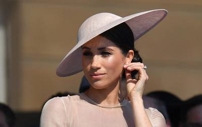 (FILES) In this file photo taken on May 22, 2018 Britain's Meghan, Duchess of Sussex, attends the Prince of Wales's 70th Birthday Garden Party at Buckingham Palace in London. A London court on March 5, 2021, ordered Britain's Mail on Sunday newspaper to publish a front-page statement after Meghan won a breach of privacy and copyright claim against it. Since moving to North America with their young son, Archie, they have launched a series of legal action against media organisations for their reporting. / AFP / POOL / Dominic Lipinski

