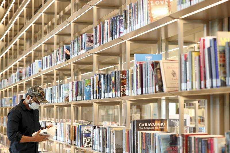 Sharjah, United Arab Emirates - December 10, 2020: News. Arts. Hussain reads a book. Opening of the House of Wisdom, a high tech new library. Thursday, December 10th, 2020 in Sharjah. Chris Whiteoak / The National