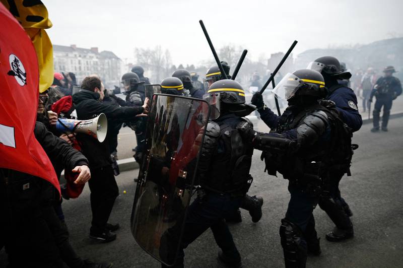 French riot police clash with protesters in Nantes, on a day of nationwide strikes and protests over proposed pension reforms. AFP