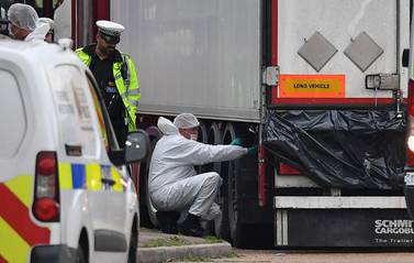 Police forensics officers examine the lorry in which 39 dead bodies were found. AFP / Ben STANSALL