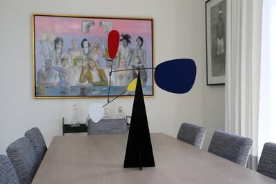 An Alexander Calder mobile from the 1930s on the walnut and wrought iron dining table.