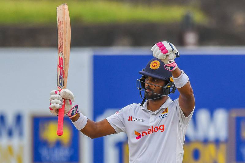 Sri Lanka's Dinesh Chandimal celebrates after scoring a half-century (50 runs) during the third day of play of the first cricket Test match between Sri Lanka and Pakistan at the Galle International Cricket Stadium in Galle on July 18, 2022.  (Photo by ISHARA S.  KODIKARA  /  AFP)