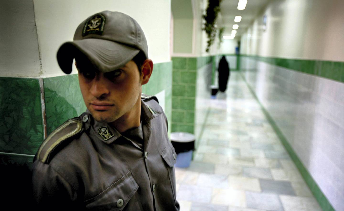 A prison guard stands along a corridor in Tehran's Evin prison June 13, 2006. Iranian police detained 70 people at a demonstration in favour of women's rights, the judiciary said on Tuesday, adding it was ready to review reports that the police had beaten some demonstrators.