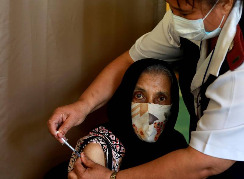 Kaironesa Suleman Allie, 76, receives a first dose of the Pfizer Covid-19 vaccine at a vaccination centre in Karl Bremer Hospital, in Cape Town, South Africa. South Africa is in a race against time to vaccinate as many people as possible with signs the virus may be surging again. AP Photo