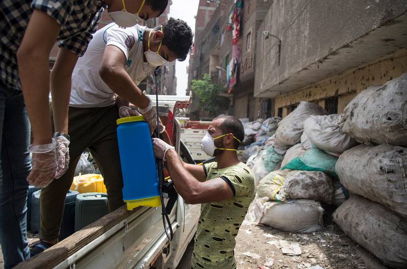 A man prepares disinfectant during a civil initiative to sterilise the Zebaalin district in Cairo, Egypt. EPA