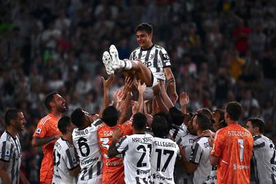 Juventus players toss teammate Paulo Dybala in the air at the end of the Serie A football match against Lazio. AFP