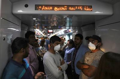 Commuters wear protective masks on the metro in Dubai, March 12. Reuters