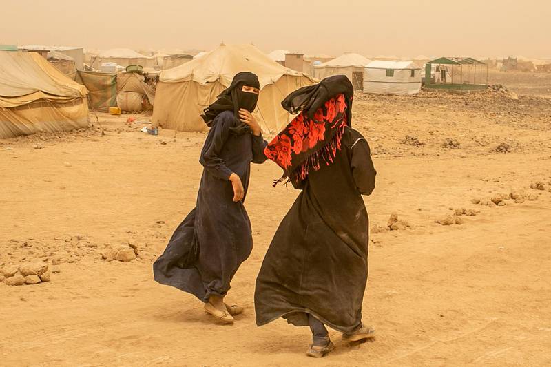 Hayat, 14, L, the daughter of a member of the pro-government forces, who used to be detained at Houthis prion, walks with her cousin around tents at a new displacement camp in Marib province.  April 4, 2021. Photo/Asmaa Waguih