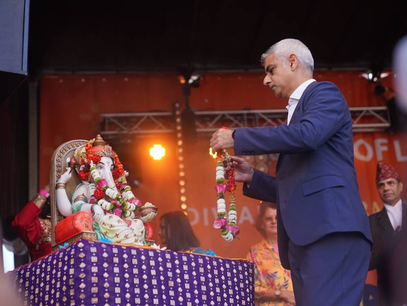 Sadiq Khan places a garland on a statue of the Hindu deity Ganesh. PA Images